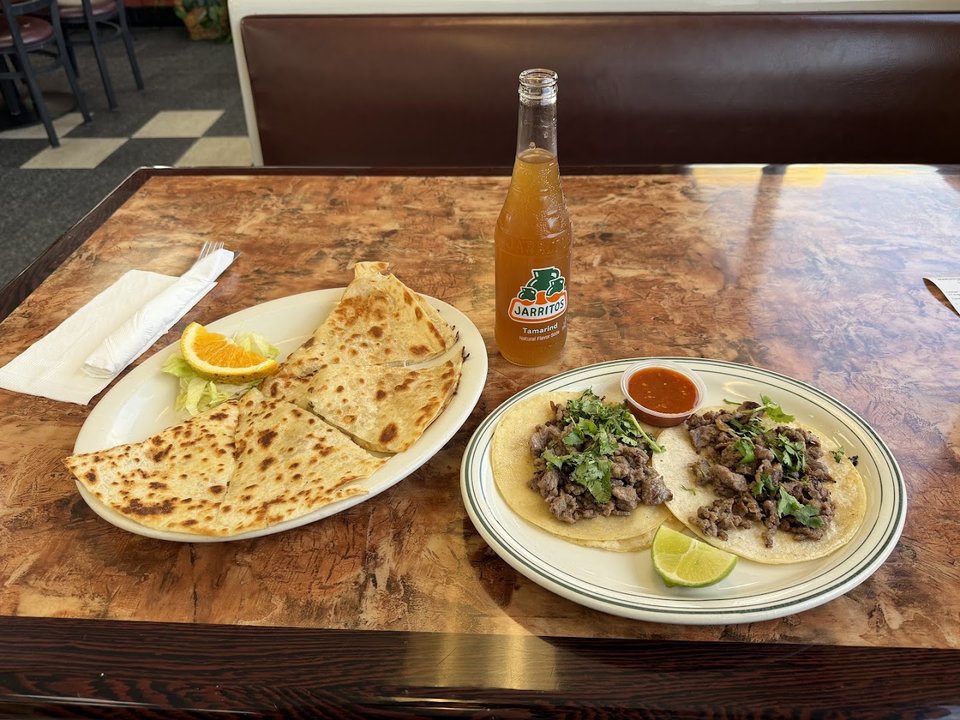 Mexican dishes served on white plates.